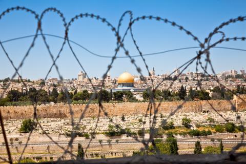 The Old City of Jerusalem seen through coils of razor wire